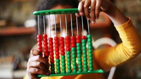 Girl learn abacus. stock image