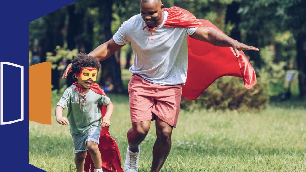 Child and father in superhero costume running outdoors